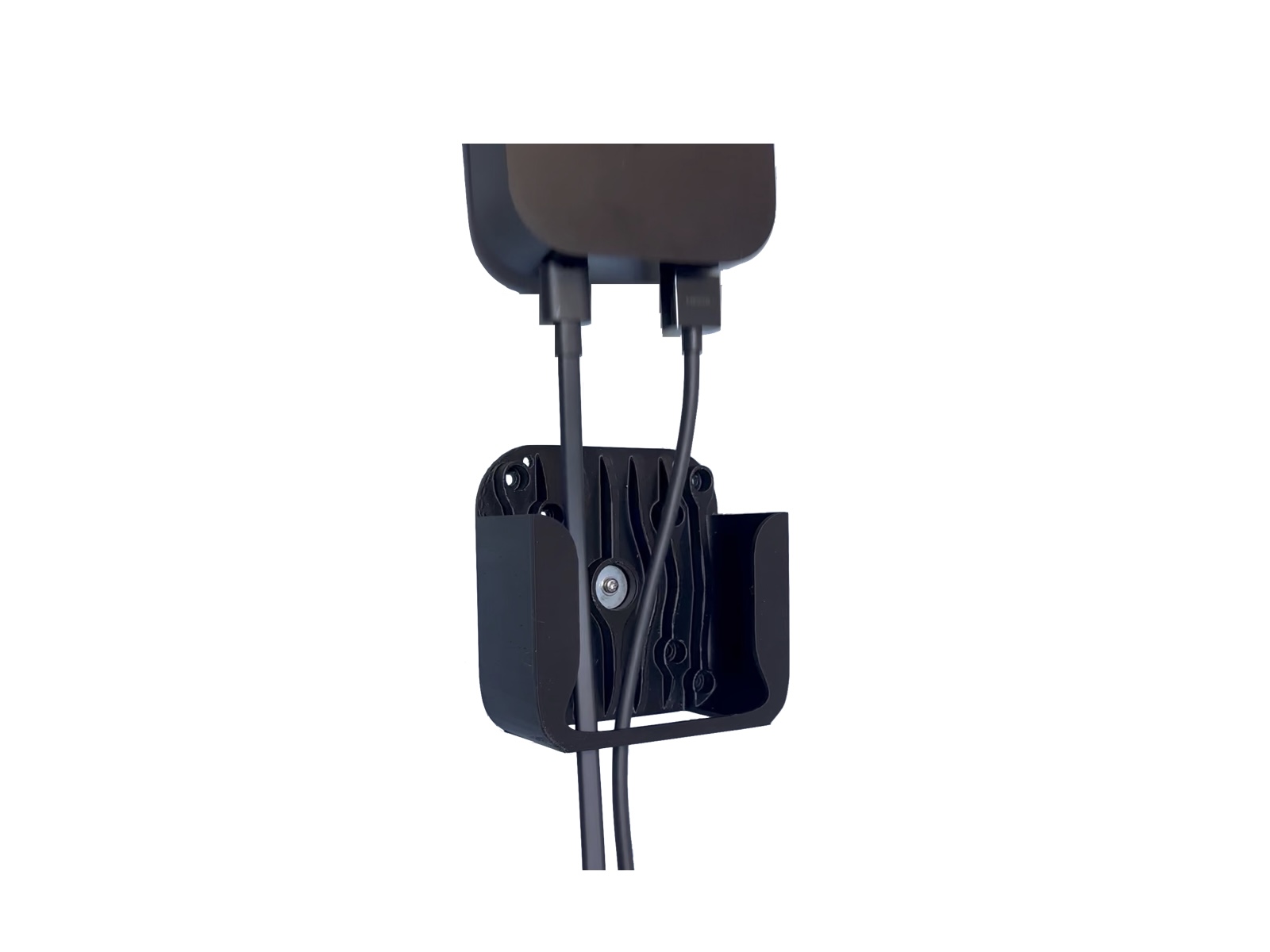 Rear view of the Apple TV holder during VESA installation with cables routed through the open cradle